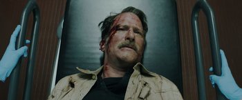 Movie still from “One Ranger” (2023), directed by Jesse V. Johnson – A person with blood on his face; Close Up shot, Low angle