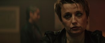 Movie still from “One Ranger” (2023), directed by Jesse V. Johnson – A person wearing a leather jacket; Close Up shot, Over the shoulder angle