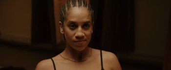 Movie still from “One Ranger” (2023), directed by Jesse V. Johnson – A person with cornrows; Close Up shot, High angle