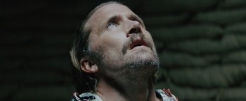 Movie still from “One Ranger” (2023), directed by Jesse V. Johnson – A person looking up at the sky; Close Up shot, Low angle