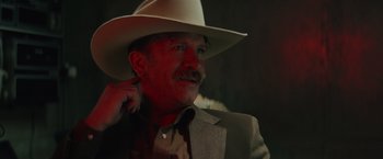 Movie still from “One Ranger” (2023), directed by Jesse V. Johnson – A man in a cowboy hat and a suit; Close Up shot, Low angle