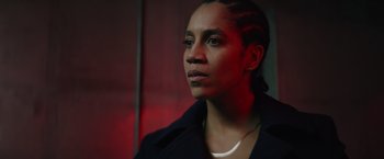 Movie still from “One Ranger” (2023), directed by Jesse V. Johnson – A woman in a black jacket looking to her left; Close Up shot, Low angle