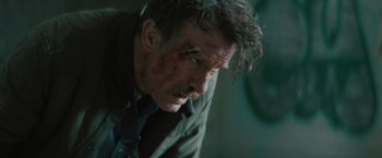 Movie still from “One Ranger” (2023), directed by Jesse V. Johnson – A person with blood on his face; Close Up shot, Low angle