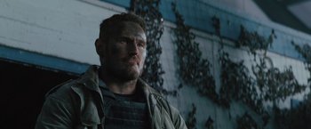 Movie still from “One Ranger” (2023), directed by Jesse V. Johnson – A person wearing a jacket and looking at the camera; Close Up shot, Low angle