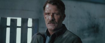 Movie still from “One Ranger” (2023), directed by Jesse V. Johnson – A person wearing a jacket; Close Up shot, Low angle