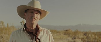 Movie still from “One Ranger” (2023), directed by Jesse V. Johnson – A man in a cowboy hat is standing in a field; Close Up shot, Low angle