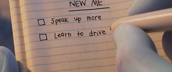 Movie still from “Onward” (2020), directed by Dan Scanlon – A hand writing on a piece of lined paper on top of a notebook; Extreme Close Up shot, Overhead angle