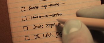 Movie still from “Onward” (2020), directed by Dan Scanlon – A person writing on a piece of paper; Extreme Close Up shot, Overhead angle