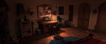 Movie still from “Onward” (2020), directed by Dan Scanlon – A person sitting at a desk in a room; Extreme Wide shot, High angle
