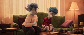 Movie still from “Onward” (2020), directed by Dan Scanlon – A couple of people sitting on top of a green couch; Medium shot, Over the shoulder angle