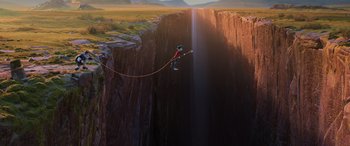 Movie still from “Onward” (2020), directed by Dan Scanlon – A person is jumping off a cliff with a rope; Extreme Wide shot, Overhead angle