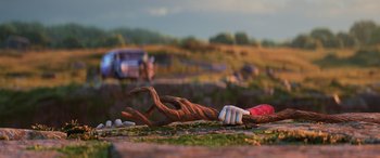 Movie still from “Onward” (2020), directed by Dan Scanlon – A wooden sculpture of a person laying on the ground; Wide shot, Low angle