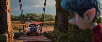 Movie still from “Onward” (2020), directed by Dan Scanlon – A police car is driving down a road; Wide shot, Low angle