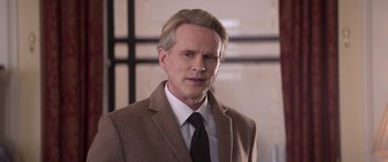 Movie still from “Operation Fortune: Ruse de Guerre” (2023), directed by Guy Ritchie – A person wearing a suit and tie; Close Up shot, Low angle