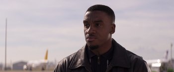 Movie still from “Operation Fortune: Ruse de Guerre” (2023), directed by Guy Ritchie – A person wearing a leather jacket; Close Up shot, Low angle