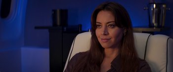 Movie still from “Operation Fortune: Ruse de Guerre” (2023), directed by Guy Ritchie – A woman sitting in an office chair in front of a window; Close Up shot, Over the shoulder angle