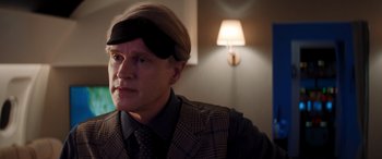 Movie still from “Operation Fortune: Ruse de Guerre” (2023), directed by Guy Ritchie – A man wearing a suit and tie with a blindfold; Close Up shot, Over the shoulder angle