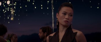 Movie still from “Operation Fortune: Ruse de Guerre” (2023), directed by Guy Ritchie – A woman in a black dress and a man in a black suit; Close Up shot, Over the shoulder angle