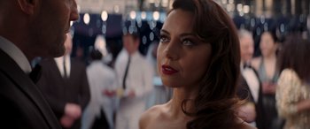 Movie still from “Operation Fortune: Ruse de Guerre” (2023), directed by Guy Ritchie – A woman with red lipstick looking to her left; Close Up shot, Over the shoulder angle