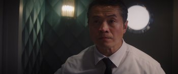 Movie still from “Operation Fortune: Ruse de Guerre” (2023), directed by Guy Ritchie – A person wearing a shirt and a tie; Close Up shot, Low angle