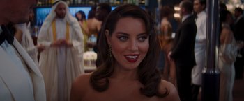 Movie still from “Operation Fortune: Ruse de Guerre” (2023), directed by Guy Ritchie – A beautiful woman with long brown hair and red lipstick; Close Up shot, Over the shoulder angle