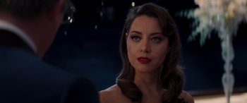 Movie still from “Operation Fortune: Ruse de Guerre” (2023), directed by Guy Ritchie – A beautiful woman with red lipstick looking at the camera; Close Up shot, Over the shoulder angle