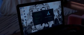 Movie still from “Operation Fortune: Ruse de Guerre” (2023), directed by Guy Ritchie – A computer screen with a computer screen with a picture of a building; Extreme Close Up shot, Over the shoulder angle