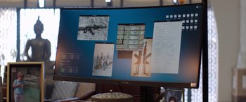 Movie still from “Operation Fortune: Ruse de Guerre” (2023), directed by Guy Ritchie – A computer screen with several pictures on it; Extreme Close Up shot, High angle