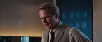 Movie still from “Operation Fortune: Ruse de Guerre” (2023), directed by Guy Ritchie – A person wearing a suit and tie; Close Up shot, Low angle