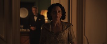 Movie still from “Operation Mincemeat” (2021), directed by John Madden – A woman standing in front of a man in a suit; Medium shot, Over the shoulder angle