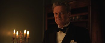 Movie still from “Operation Mincemeat” (2021), directed by John Madden – A person wearing a suit and a bow tie; Close Up shot, Low angle