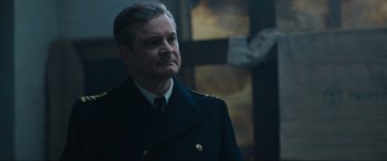 Movie still from “Operation Mincemeat” (2021), directed by John Madden – A person wearing a suit and tie; Close Up shot, Low angle