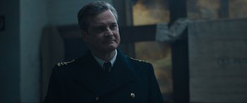 Movie still from “Operation Mincemeat” (2021), directed by John Madden – A person wearing a military uniform; Close Up shot, Low angle