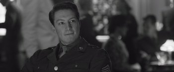 Movie still from “Operation Mincemeat” (2021), directed by John Madden – A man in a military uniform is looking at the camera; Close Up shot, Over the shoulder angle