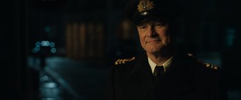 Movie still from “Operation Mincemeat” (2021), directed by John Madden – A person wearing a uniform; Close Up shot, Over the shoulder angle