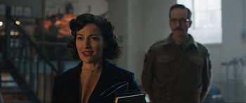 Movie still from “Operation Mincemeat” (2021), directed by John Madden – A woman in a black jacket and a man in a brown jacket; Close Up shot, Over the shoulder angle