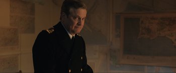 Movie still from “Operation Mincemeat” (2021), directed by John Madden – A person wearing a military uniform; Close Up shot, Over the shoulder angle