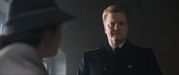 Movie still from “Operation Mincemeat” (2021), directed by John Madden – A person wearing a uniform; Close Up shot, Over the shoulder angle