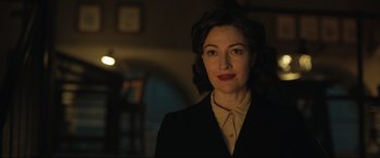 Movie still from “Operation Mincemeat” (2021), directed by John Madden – A woman in a black jacket and a white shirt; Close Up shot, Over the shoulder angle