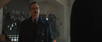 Movie still from “Operation Mincemeat” (2021), directed by John Madden – A man in a suit and tie standing in front of a mirror; Close Up shot, Over the shoulder angle