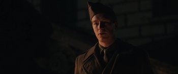 Movie still from “Operation Mincemeat” (2021), directed by John Madden – A man wearing a hat and a uniform; Medium shot, Low angle