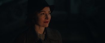 Movie still from “Operation Mincemeat” (2021), directed by John Madden – A woman in a hat and a jacket looking to her left; Close Up shot, Over the shoulder angle