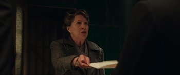 Movie still from “Operation Mincemeat” (2021), directed by John Madden – An older woman is holding a paper in her hand; Close Up shot, Over the shoulder angle