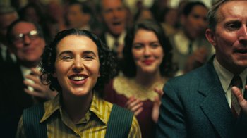 Movie still from “Oppenheimer” (2023), directed by Christopher Nolan – A group of people standing next to each other in a room; Close Up shot, Low angle