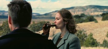 Movie still from “Oppenheimer” (2023), directed by Christopher Nolan – A man and a woman are smoking a cigar; Medium shot, Over the shoulder angle