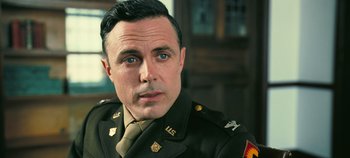 Movie still from “Oppenheimer” (2023), directed by Christopher Nolan – A person wearing a military uniform; Close Up shot, Over the shoulder angle