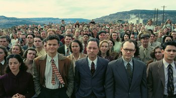 Movie still from “Oppenheimer” (2023), directed by Christopher Nolan – A large group of people standing in front of each other; Wide shot, High angle