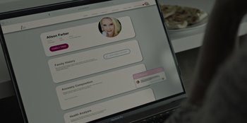 Movie still from “Our Father” (2022), directed by Lucie Jourdan – A computer screen showing a person's profile and health analysis information; Extreme Close Up shot, Over the shoulder angle