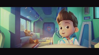A boy is sitting in a chair with a teddy bear
