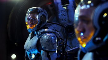 Movie still from “Pacific Rim” (2013), directed by Guillermo del Toro – A man in a space suit is standing in front of a mirror; Medium shot, Over the shoulder angle